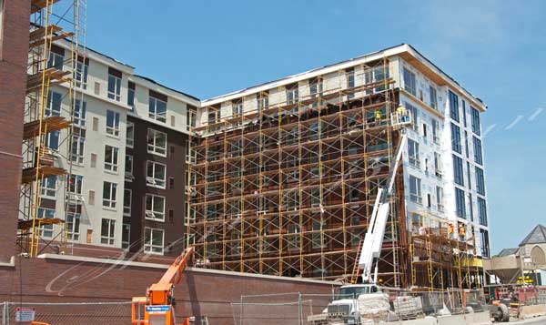 Apartment building under construction, college dorm under construction