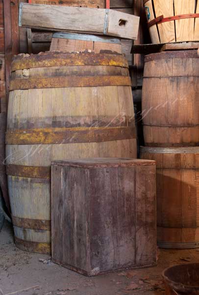Wooden whiskey barrel with metal bands.  Wooden nail keg.  Wooden boxes and crates.