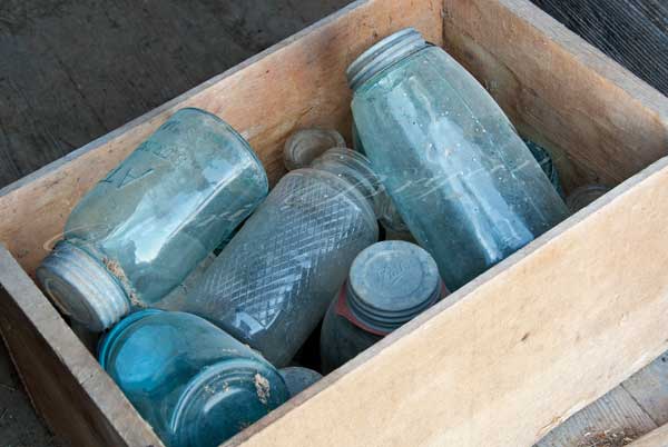 Collectable blue glass Atlas Ball canning jars with lids in a wooden box