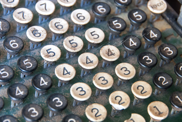 Black and white numbers on a vintage, antique adding machine. Number 2, 3, 4, 5, 6, 7 Repeat