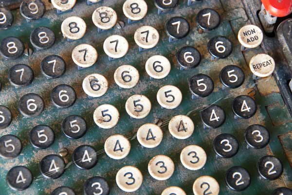 Black and white numbers on a vintage, antique adding machine. Number 2, 3, 4, 5, 6, 7 Repeat