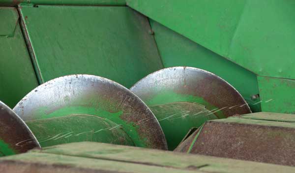 Corn header auger on a combine Potentially dangerous farm equipment