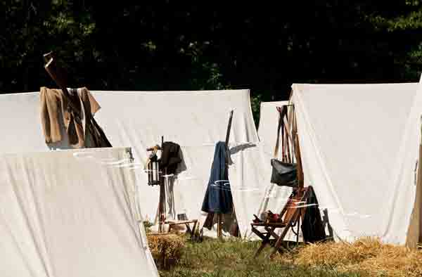 Civil War reenactment at the Centralia  Battlefield In Boone County Missouri.  Civil War era costumes and props, White tent, Rifle, Pistol, Coat, Rucksack