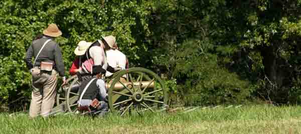 Civil War reenactment with reenactors firing a smoking canon on the Centralia Missouri Battlefield In Boone County.  Civil War era costumes and props